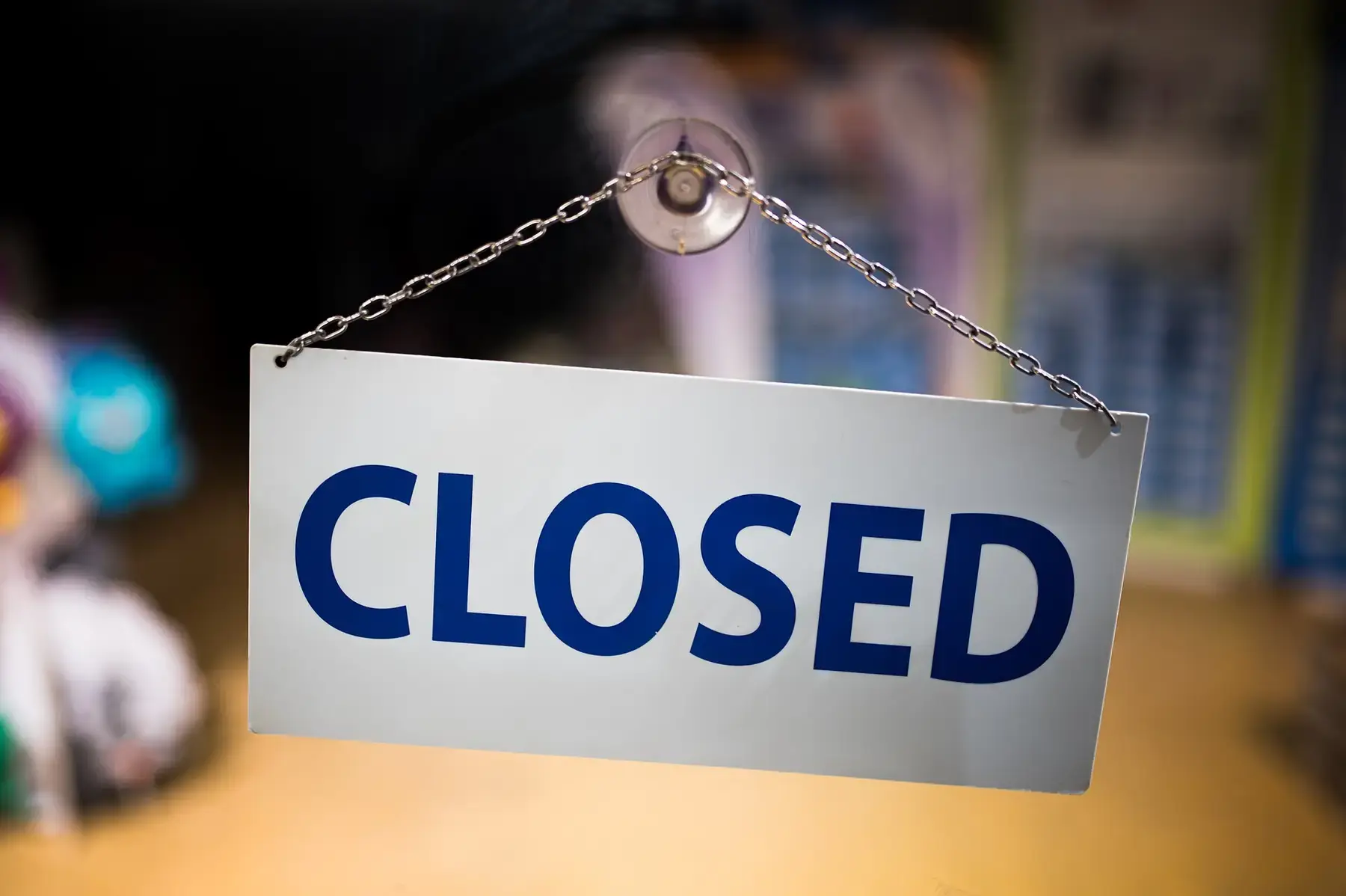 A closed sign hanging on a shop door