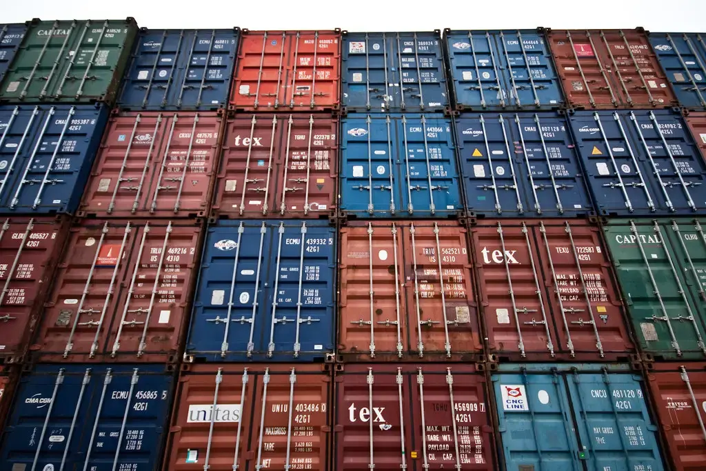 A wall of stacked shipping containers