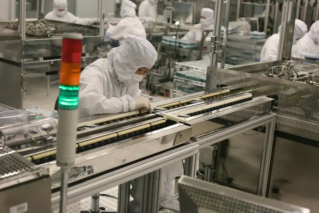 Technicians at a production line in a clean room