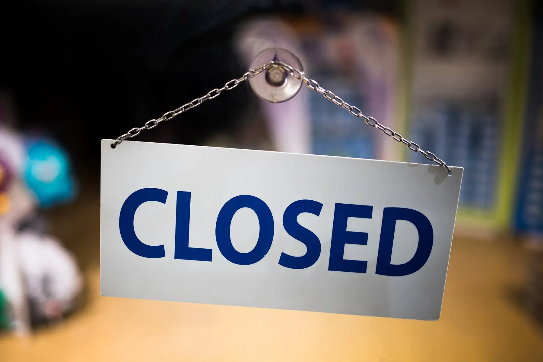 A closed sign hanging on a shop door