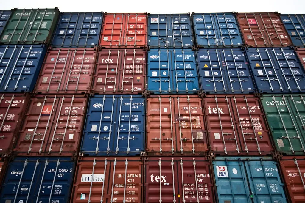 A wall of stacked shipping containers