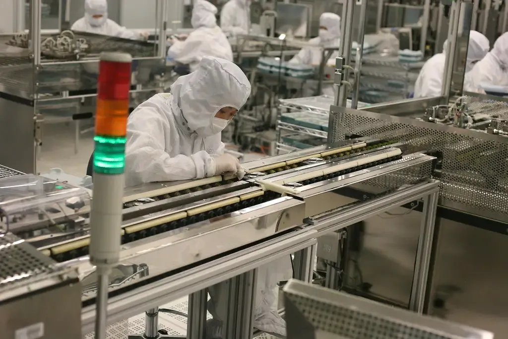 Technicians at a production line in a clean room